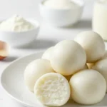 Sweet and soft Milk Balls made from milk powder, sugar, and ghee, served as a delicious snack or festive treat.