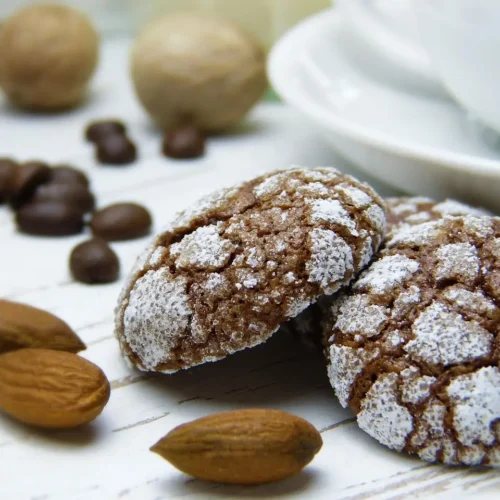 A plate of warm, spiced nutmeg cookies dusted with powdered sugar, perfect for the holiday season.